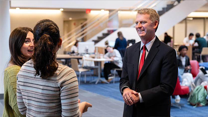 Image of President Weinman and students.